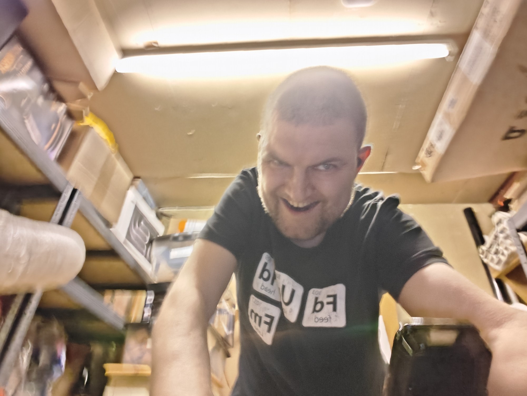 A picture of me, Martin Eve, on an indoor exercise bike with a Feed Your Head radio show t shirt on