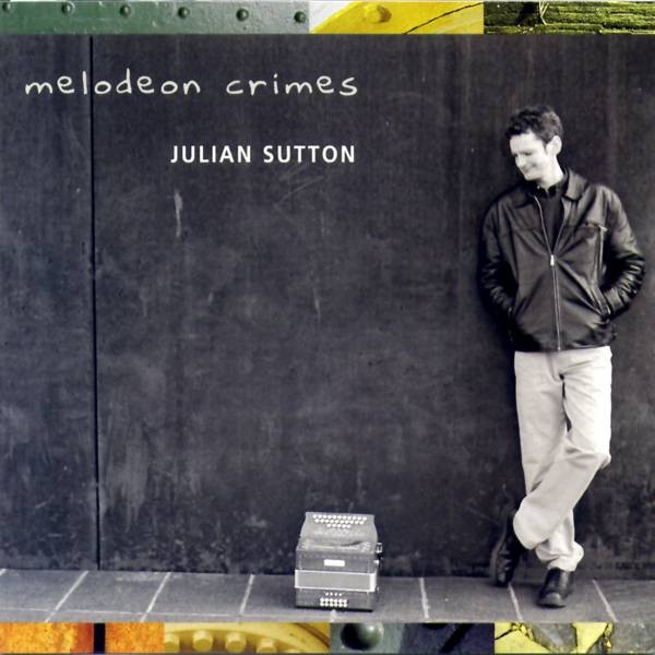 The cover of Julian Sutton's Melodeon Crimes featuring the artist standing casually against a black wall, looking down at a melodeon. 