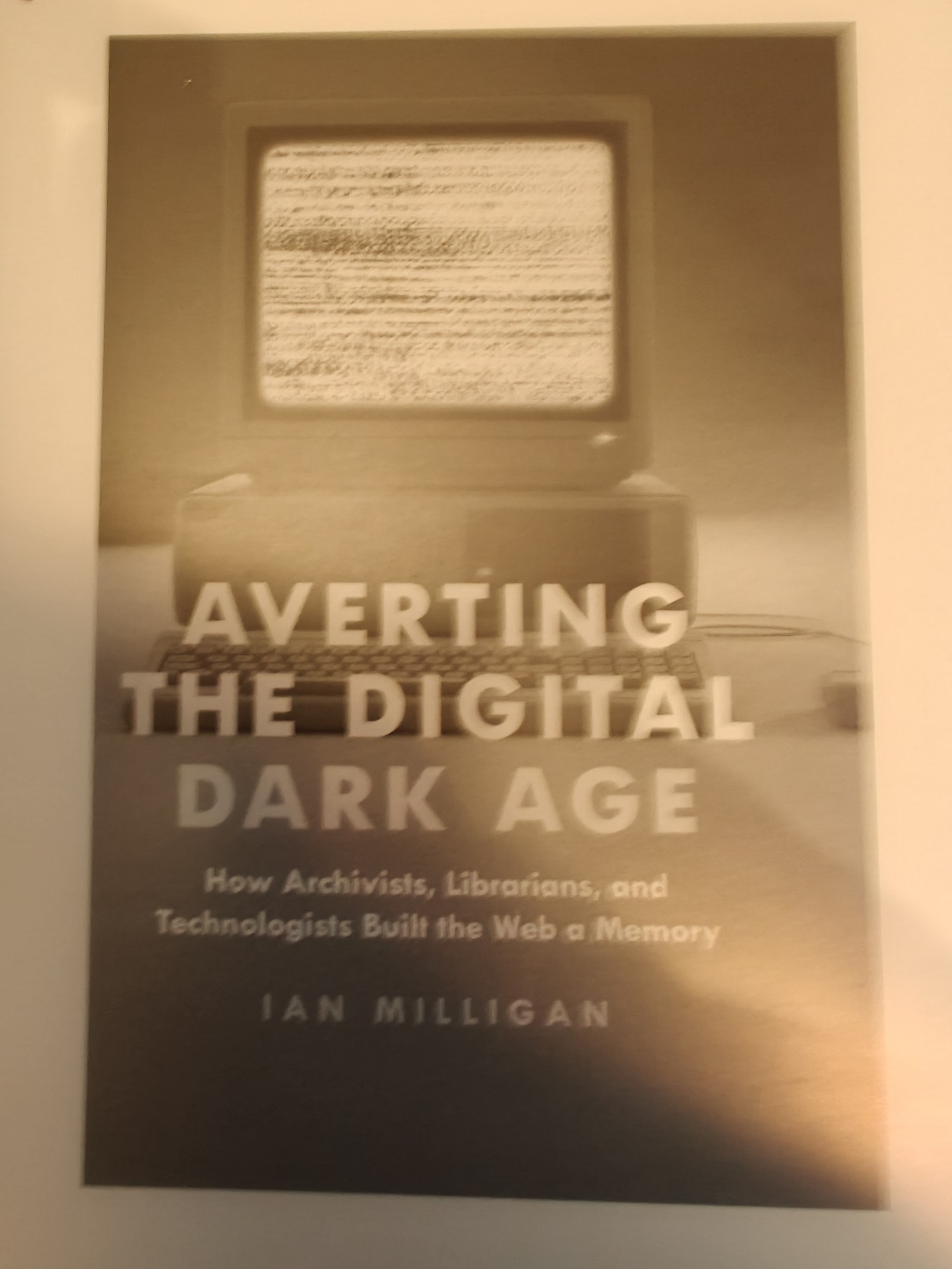 An eReader display of Averting the Digital Dark Age, by Ian Milligan. It shows a computer on a desk