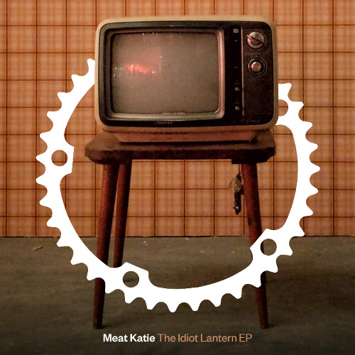 The cover for Meat Katie - The Idiot Lantern EP. It's a television with the tici taci cogs around it with a 1980s style brown square background.