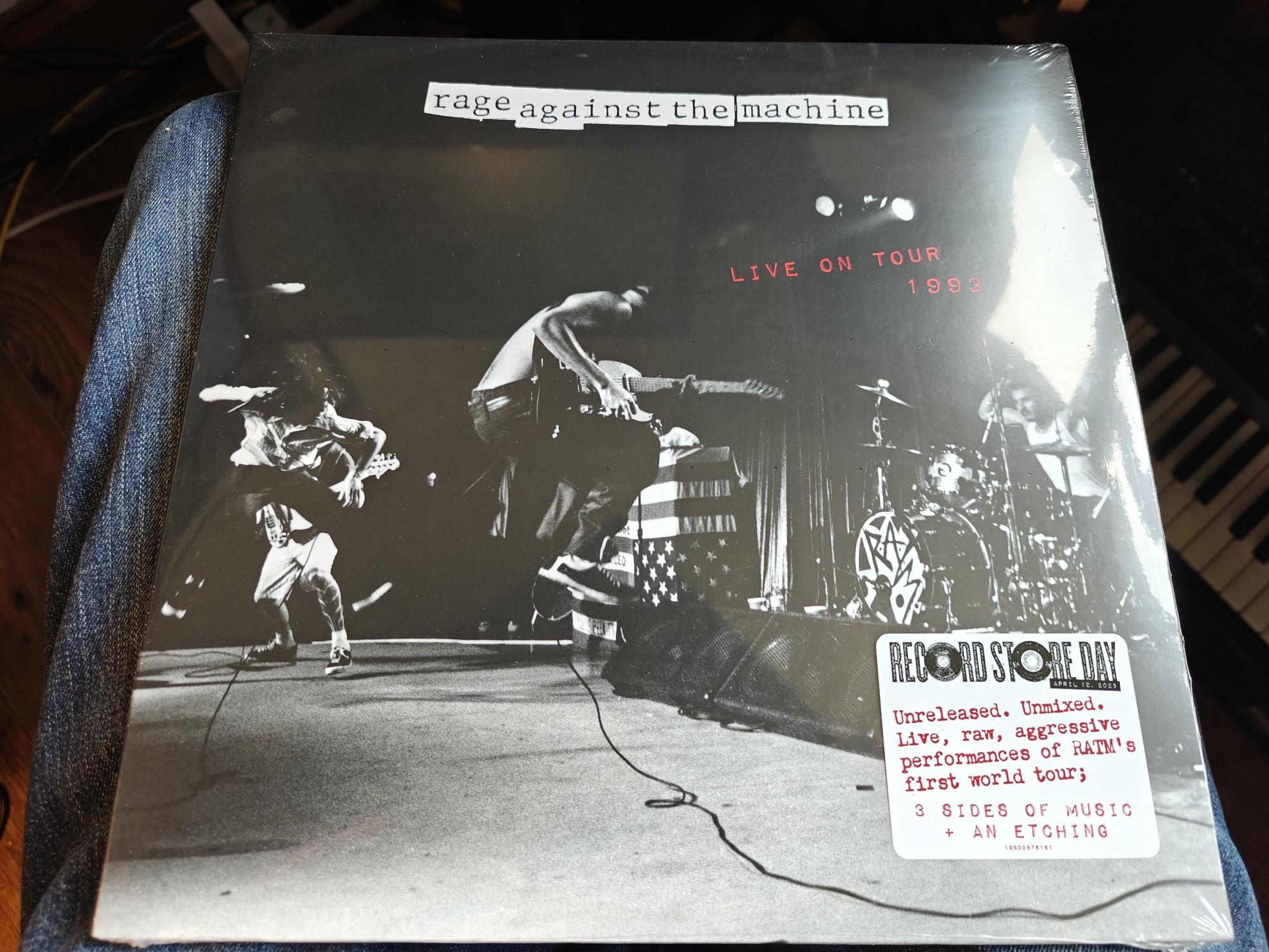 The cover of the record Rage Against the Machine Live on Tour 1993. It features the band playing in black and white. 