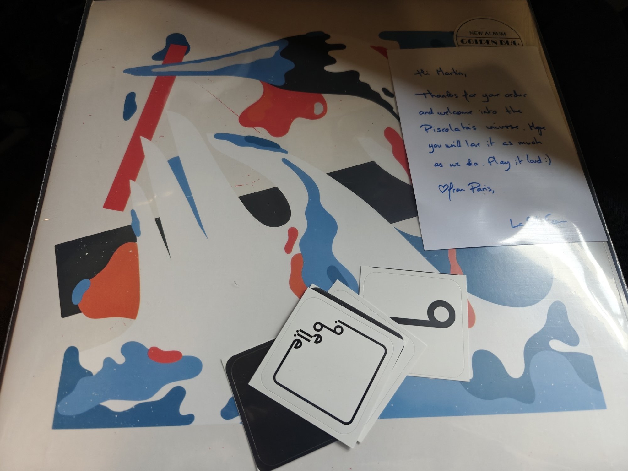 The abstract art cover of a Golden Bug record, in red white and blue. 