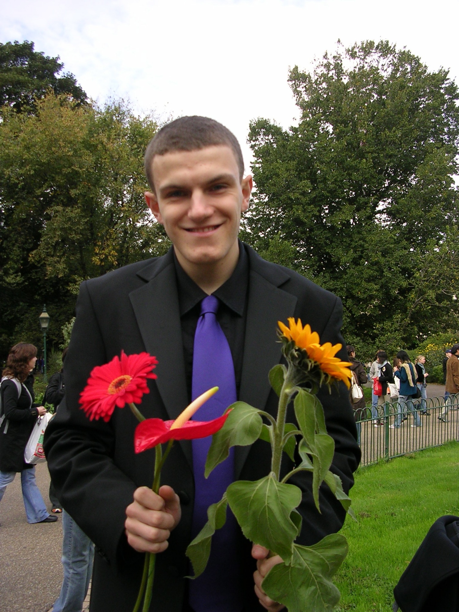 A picture of me from 2005, holding some flowers 