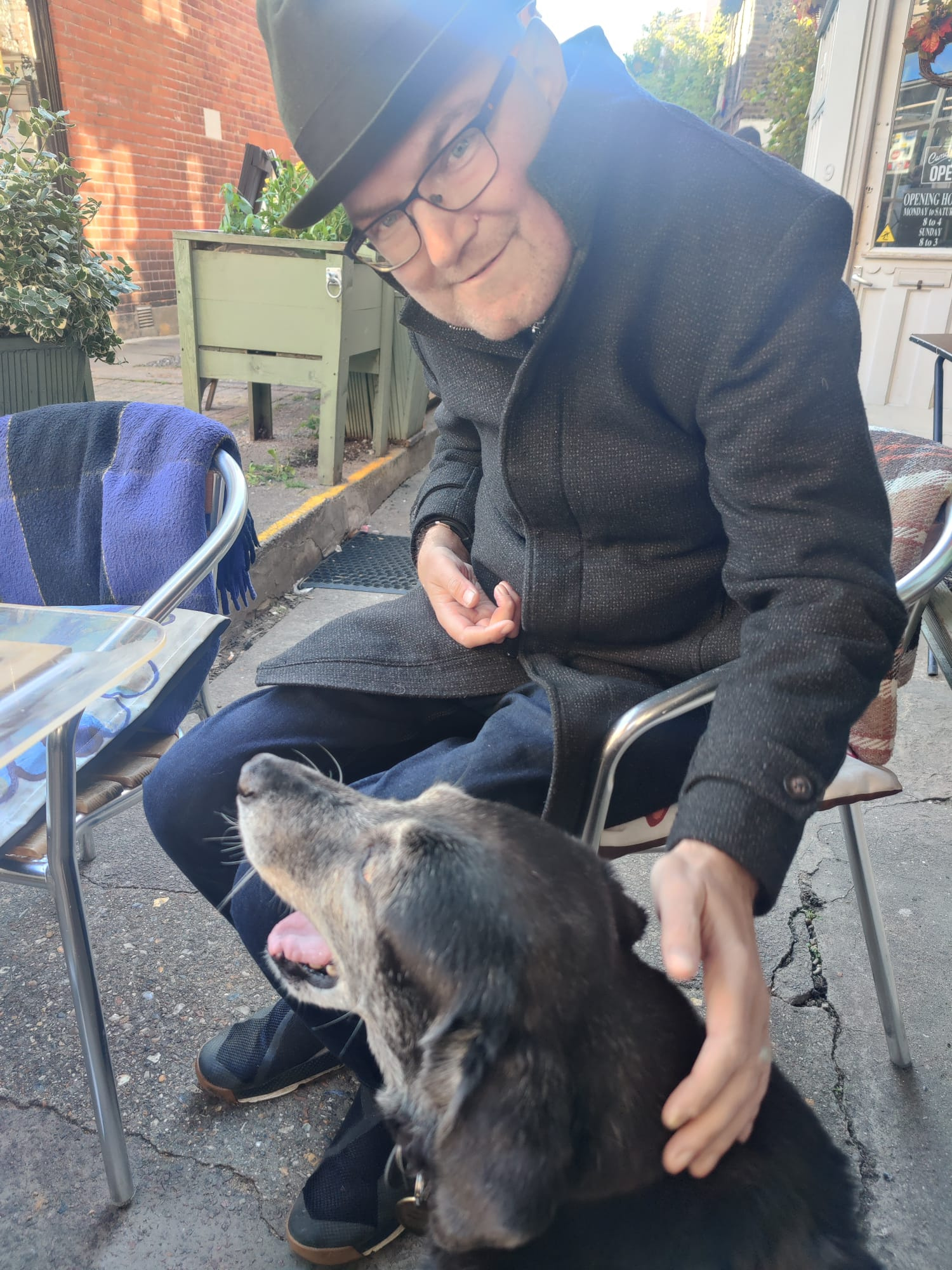 A picture of me stroking a black dog