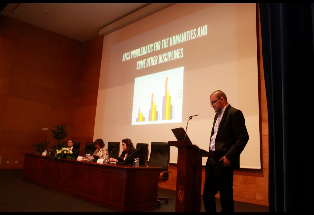 Me talking at a conference in Portugal, with a slide saying "APCS PROBLEMATIC FOR THE HUMANITIES AND SOME OTHER DISCIPLINES" 