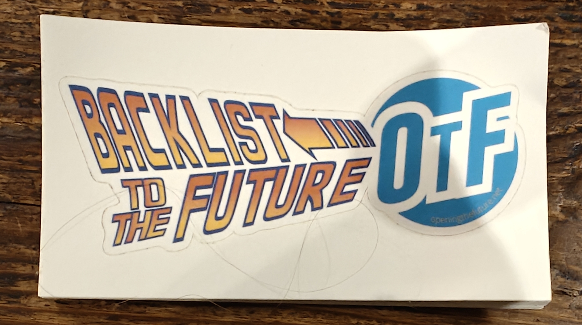 Stickers with the text Backlist to the Future in the style of Back to the Future, and the OtF logo. 