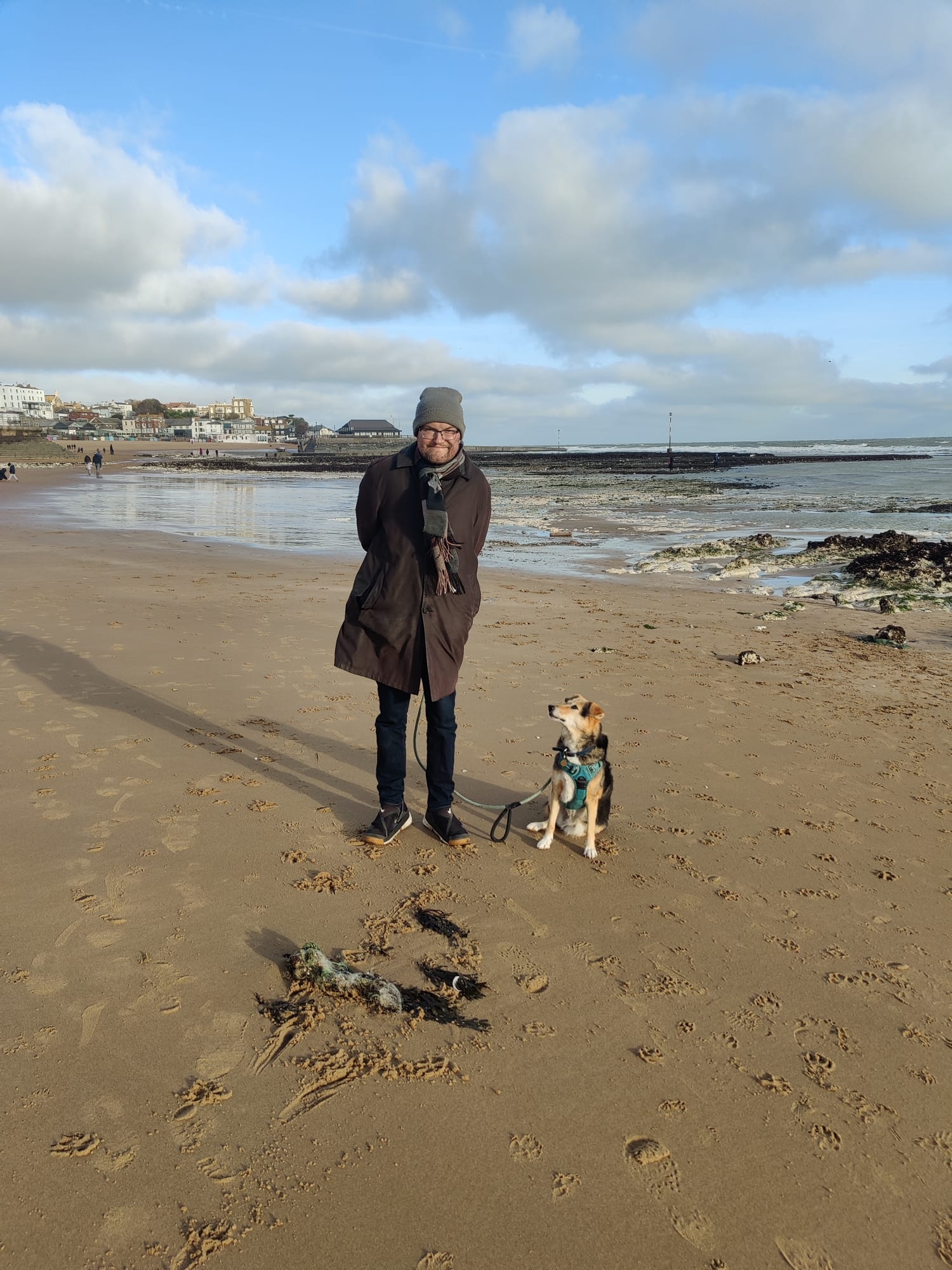 Me standing on the beach with my dog, Robyn 