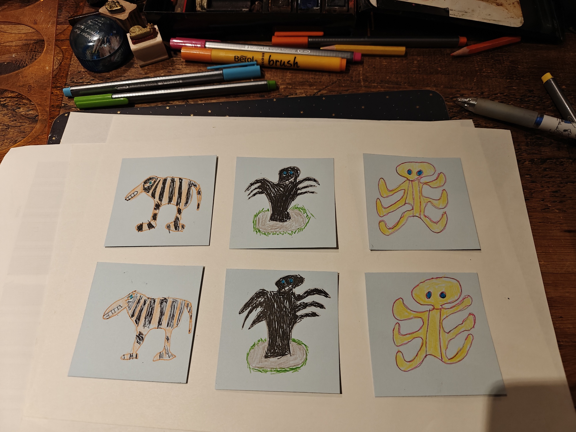 Some very bad drawings of a tiger a mole and an octopus with 6 legs