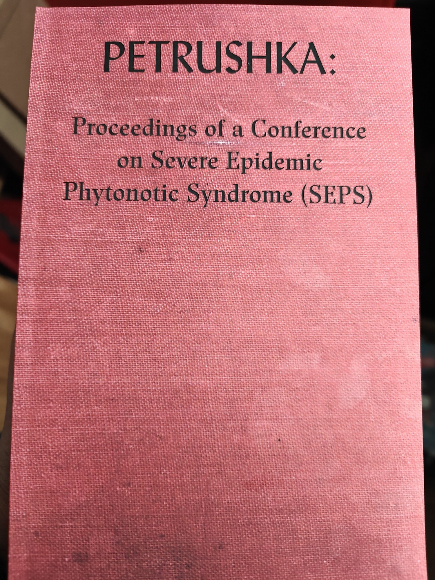 The cover to Petrushka : Proceedings of a Conference on Severe Epidemic Phytonic Syndrome (SEPS). It's red and looks faded. 