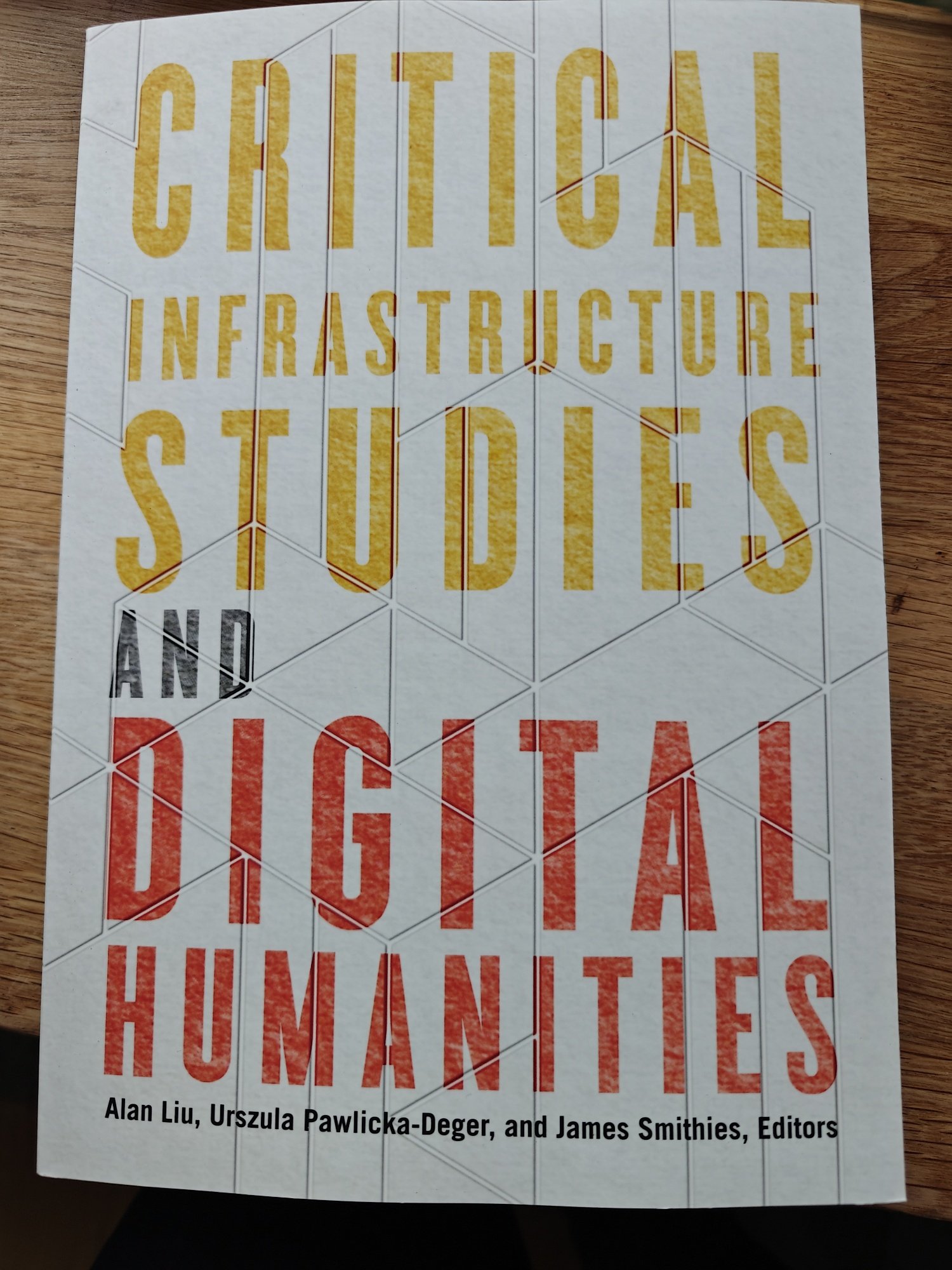 The cover of Critical Infrastructure Studies and Digital Humanities with the top words in yellow and the bottom in red 