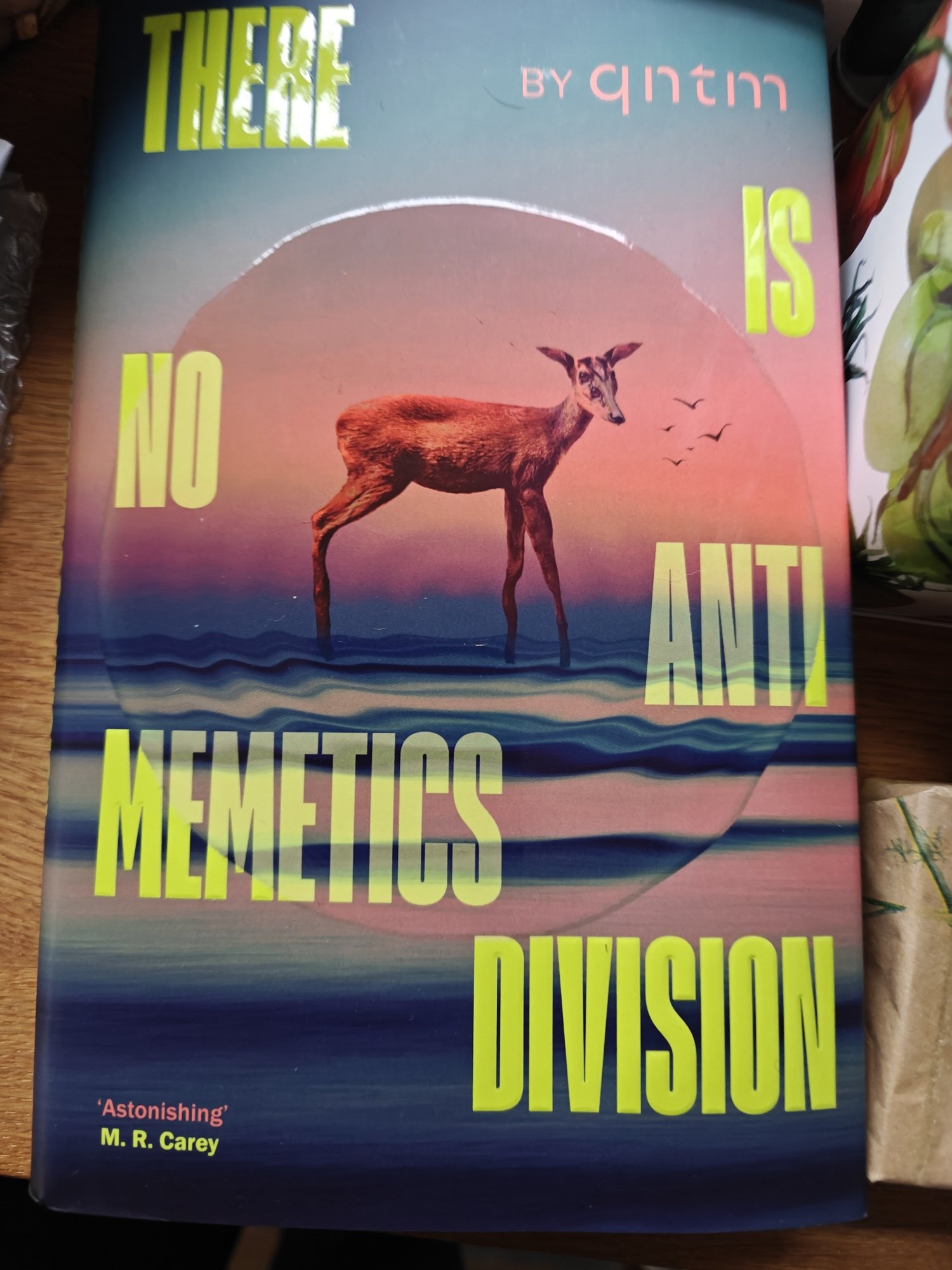 The cover of THERE IS NO ANTI-MEMETICS DIVISION. It has a deer-like animal walking on waves
