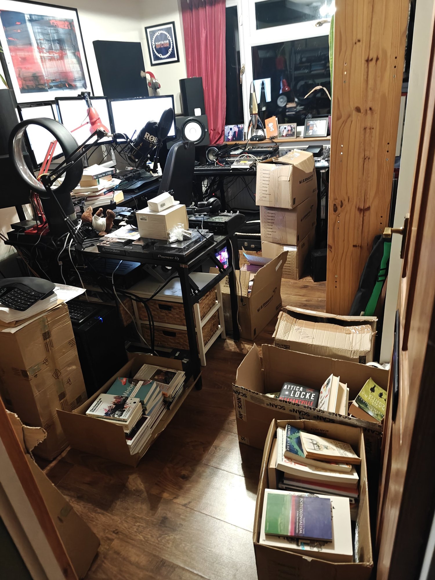 An untidy office full of boxes of books