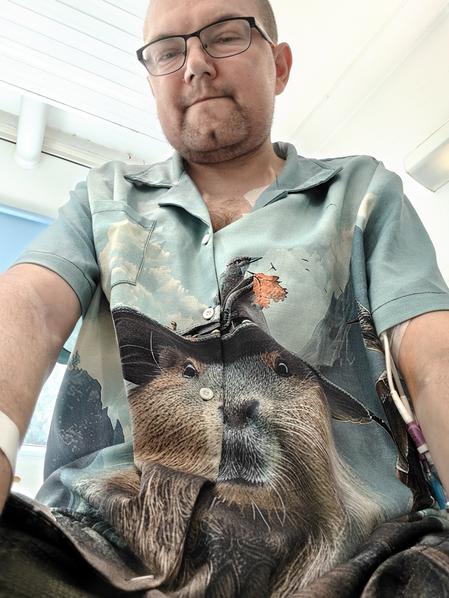 A picture of me in my capybara wizard shirt for dialysis. It features a capybara in a wizard hat. 