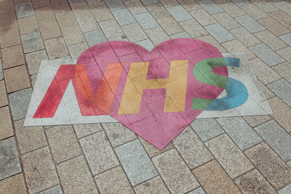 A heart graffited onto the pavement that says NHS